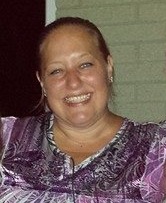picture of jamey smiling with her hair up and a purple shirt on